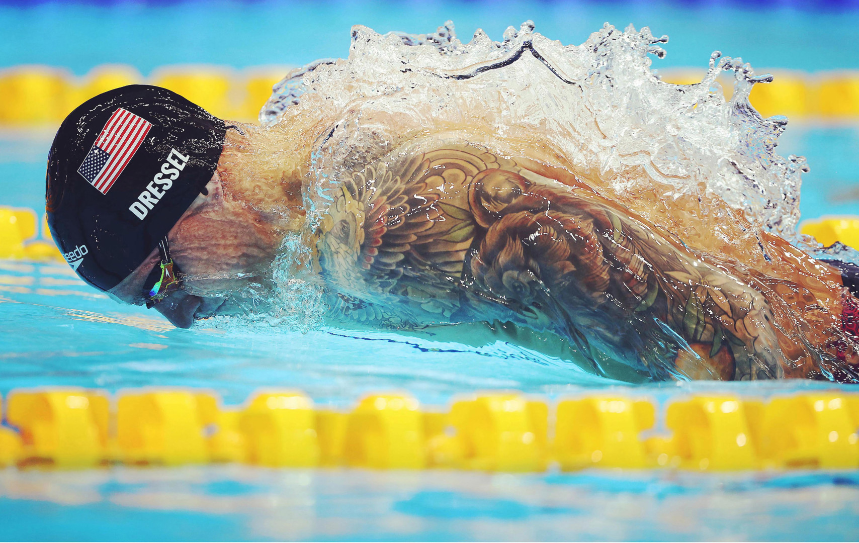 Swimmer Caeleb Dressel gliding through water in lane.