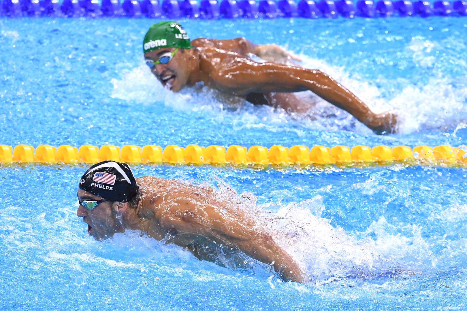 American and South African swimmers in sync as they take a breath during Butterfly stroke in race.