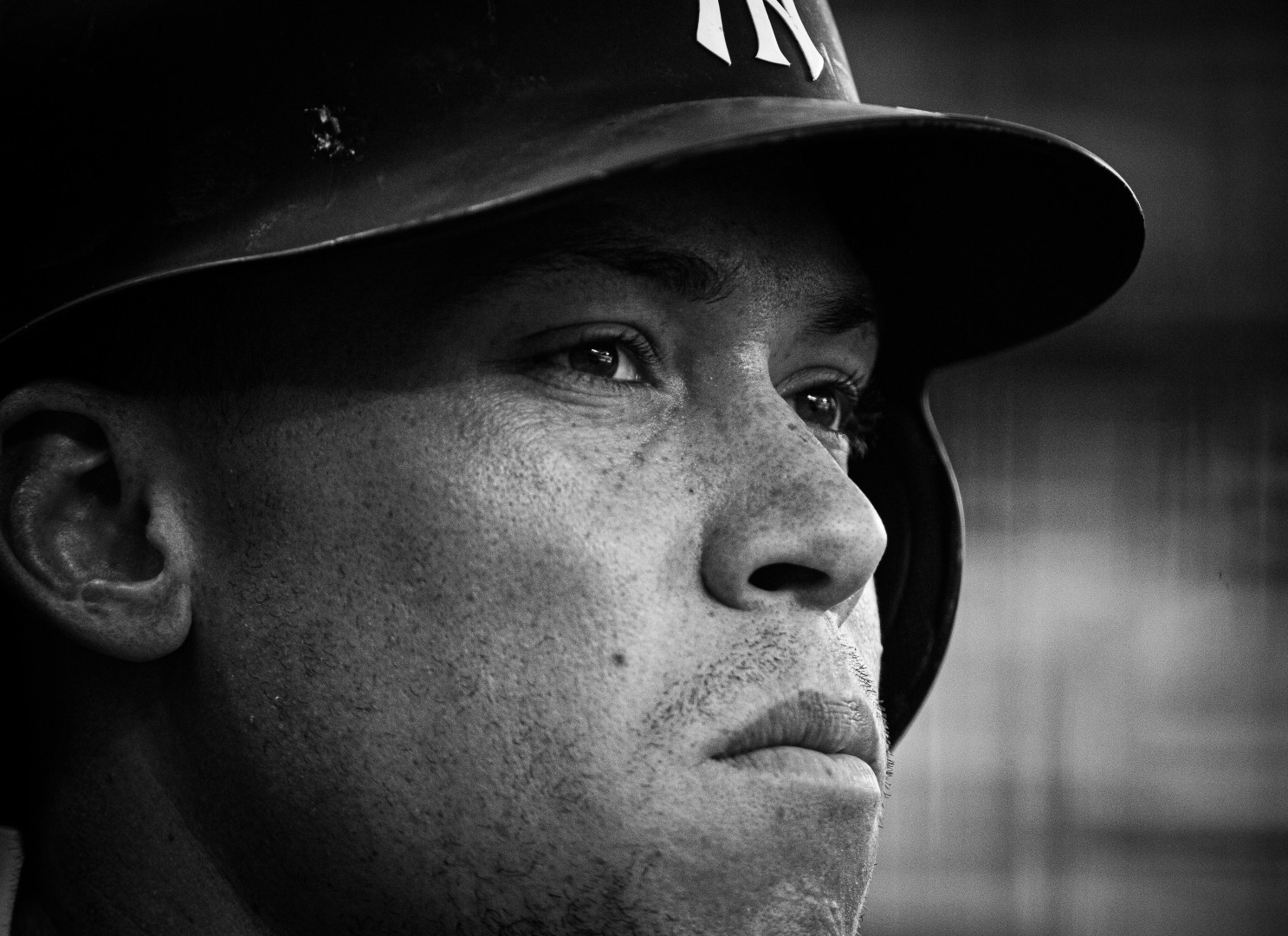 Up close head shot of baseball player surveying the match.
