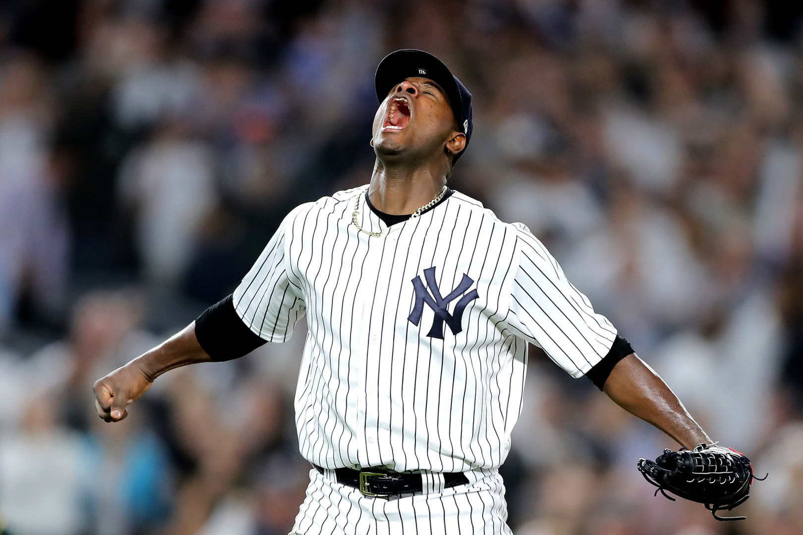 Severino shouting to the sky as he celebrates baseball match win.