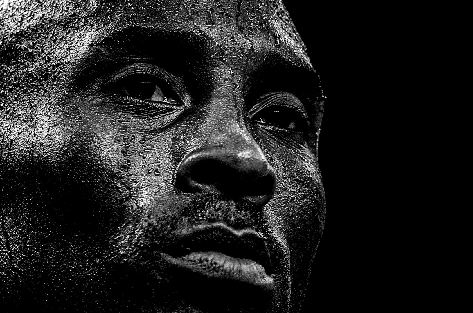 Close up black & white head shot of Kobe Bryant.