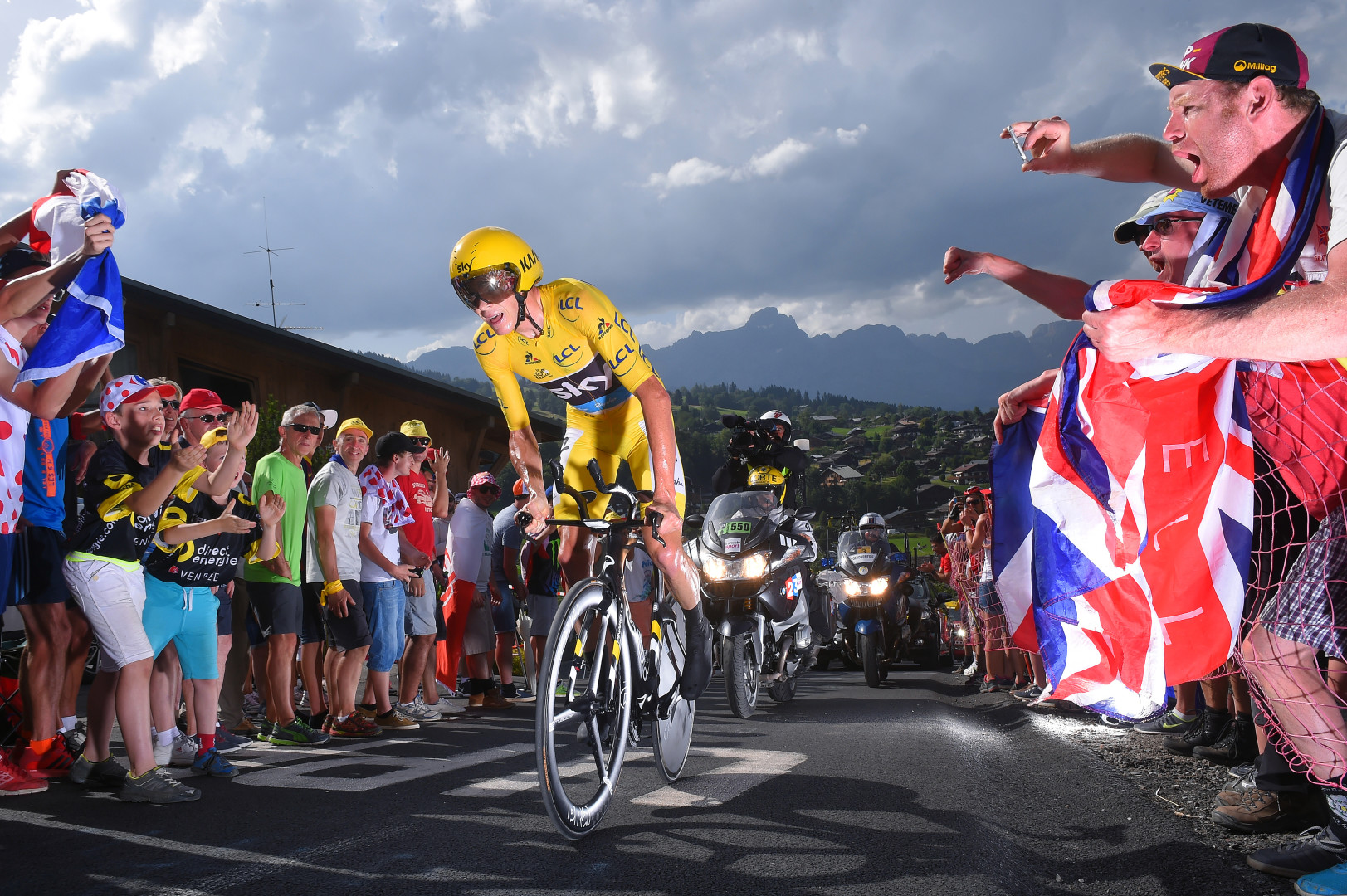 Yellow road cyclist fighting to climb a hill in order to win race.