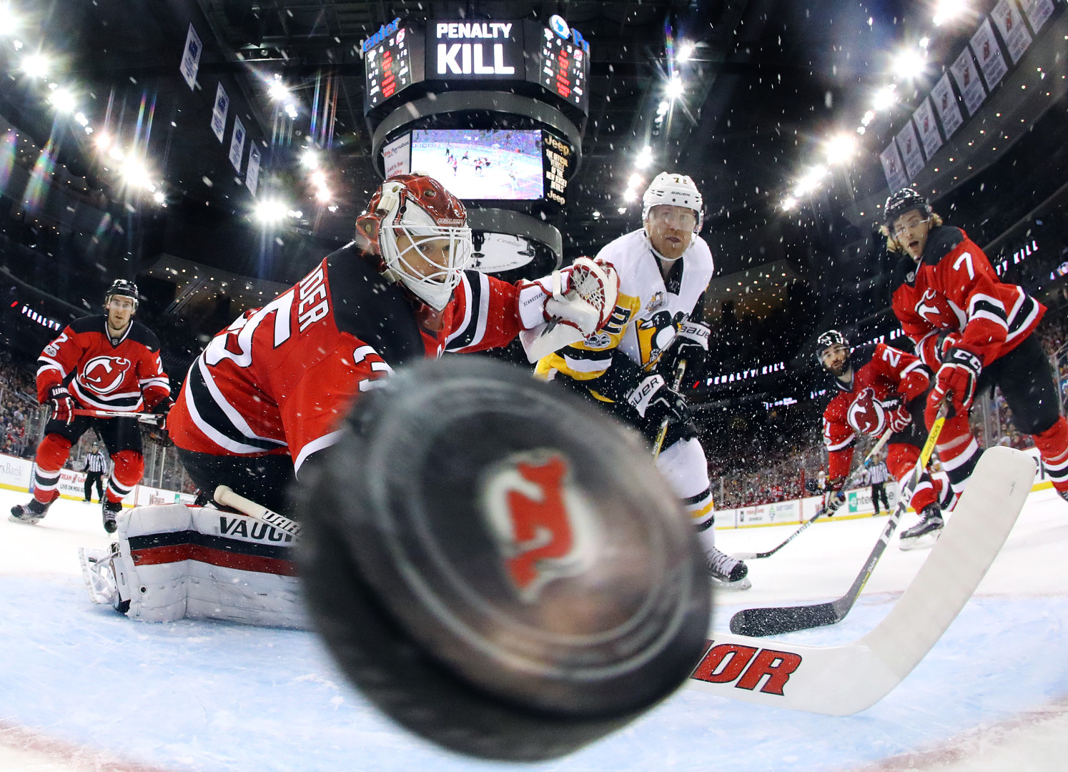 Fisheye photograph of the puck flying into the goal during a Ice Hockey game.