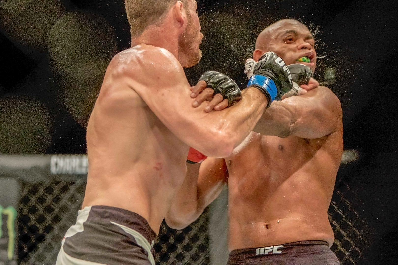 Competitor land a punch to the face during a UFC Fight Night match resulting in spray of bodily fluids.