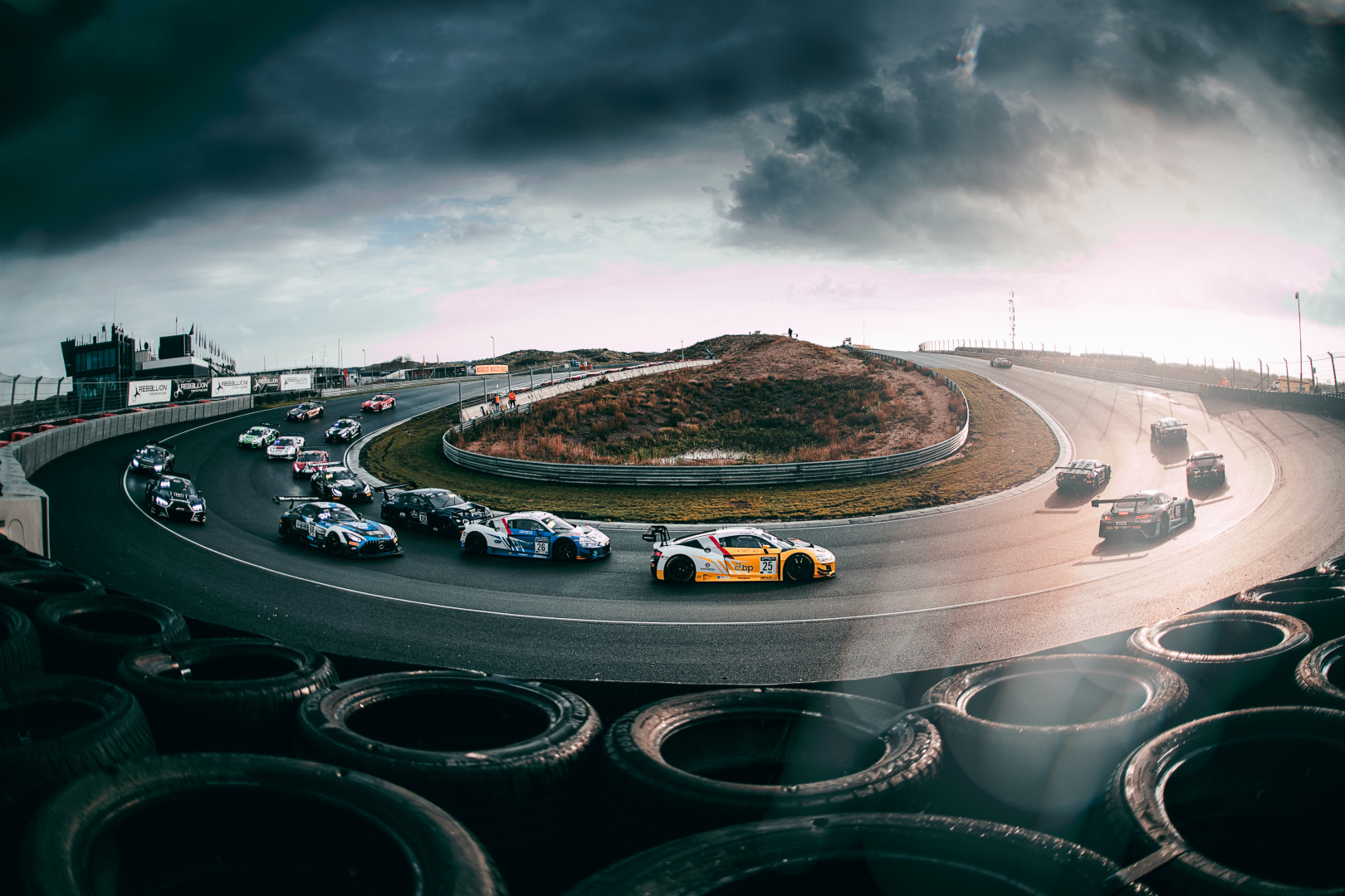 Fisheye photograph of F1 cars on bend of the Zandvoort Circuit.