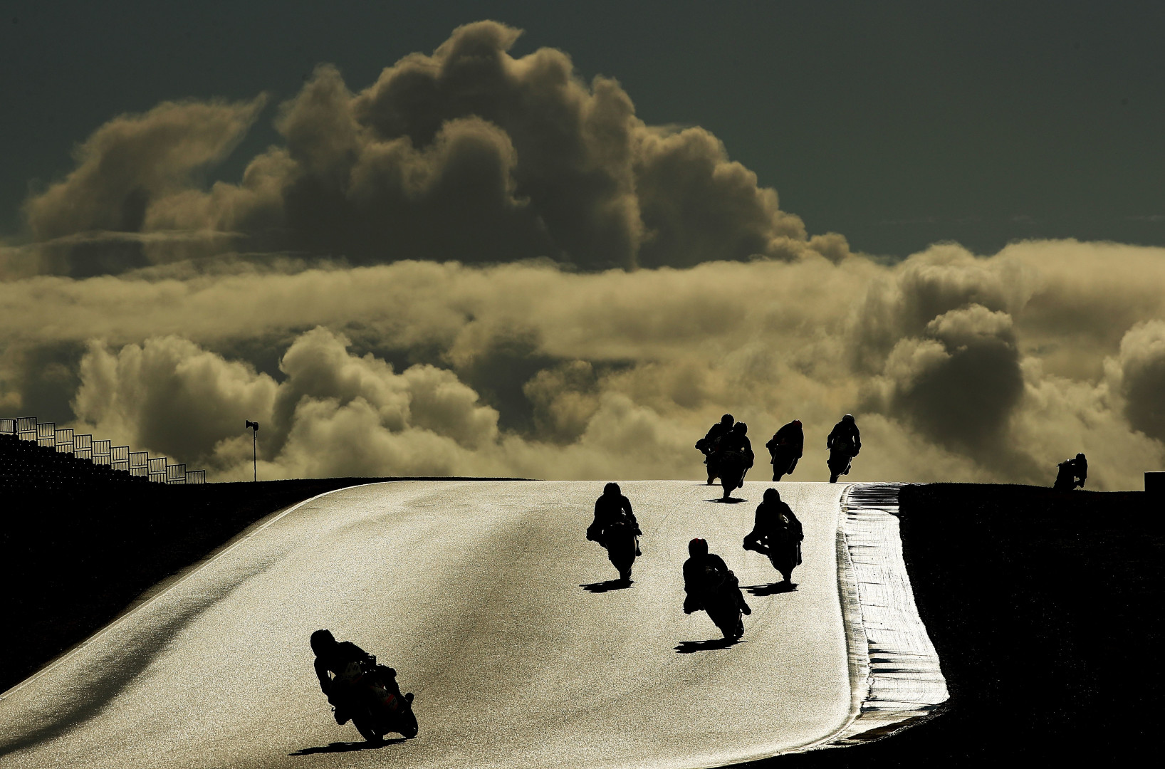 Silhouettes of motorcyclists on the track at the 2016 Australian MotoGP.