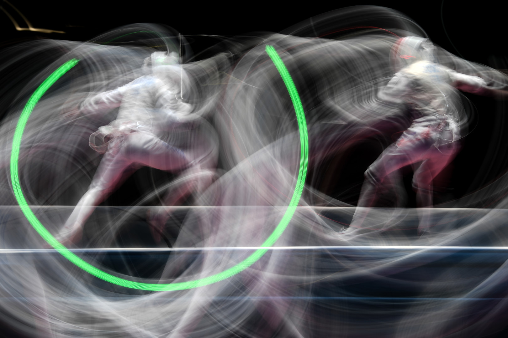 Fencing competitors creating whips and lines of movement in colour during competition.