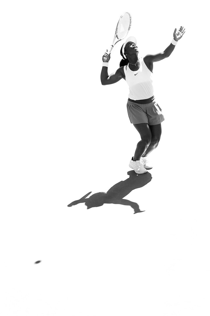 Black & White image of Sachia Vickery making a serve on the tennis court.