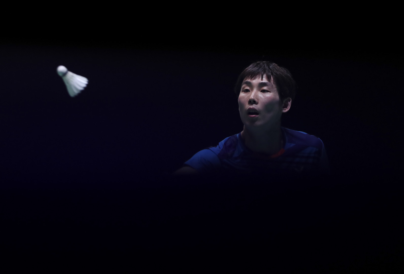 Strip of light catches badminton player making a serve.