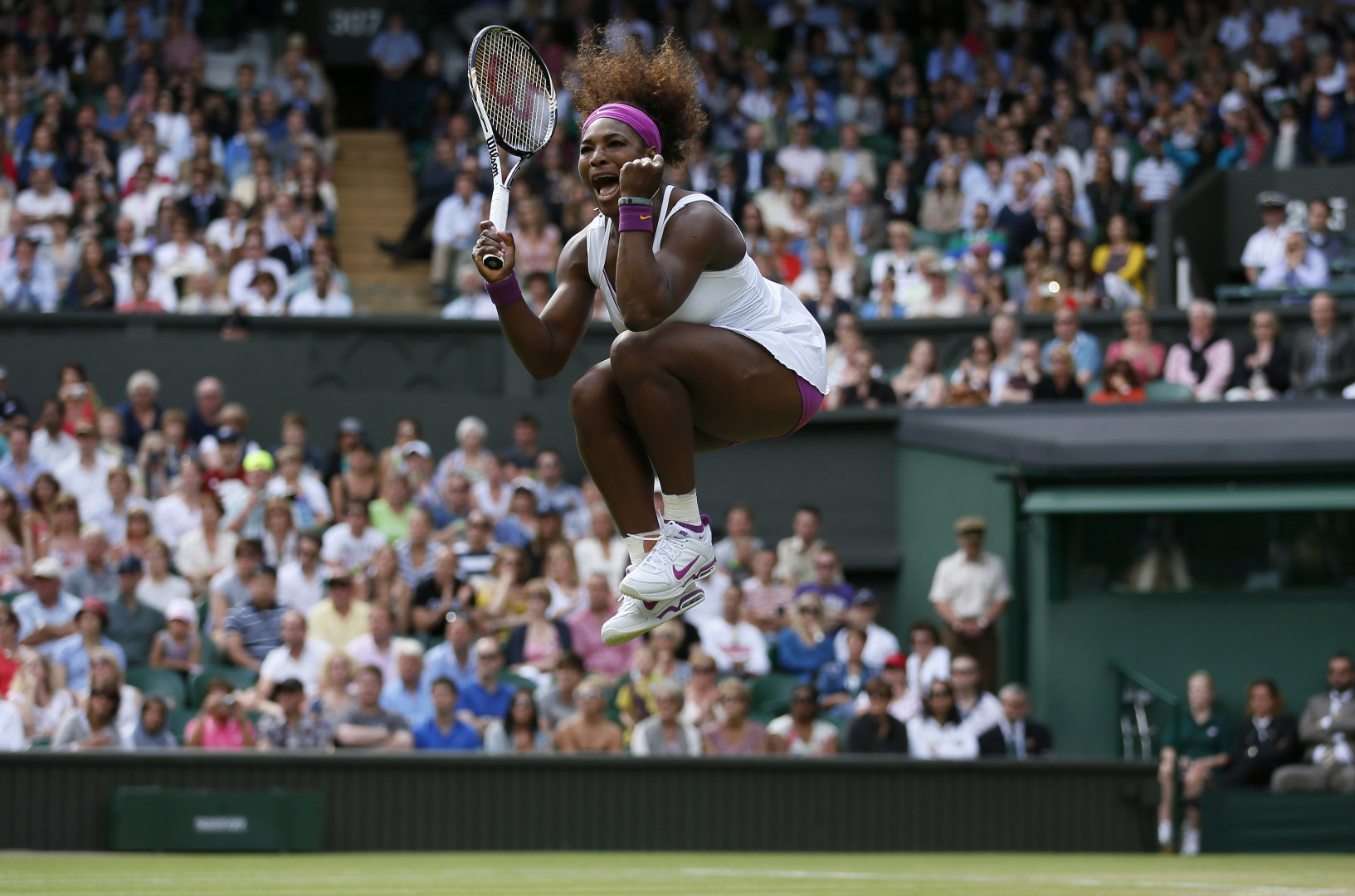 Serena Williams jumping for join as she wins a tennis match.
