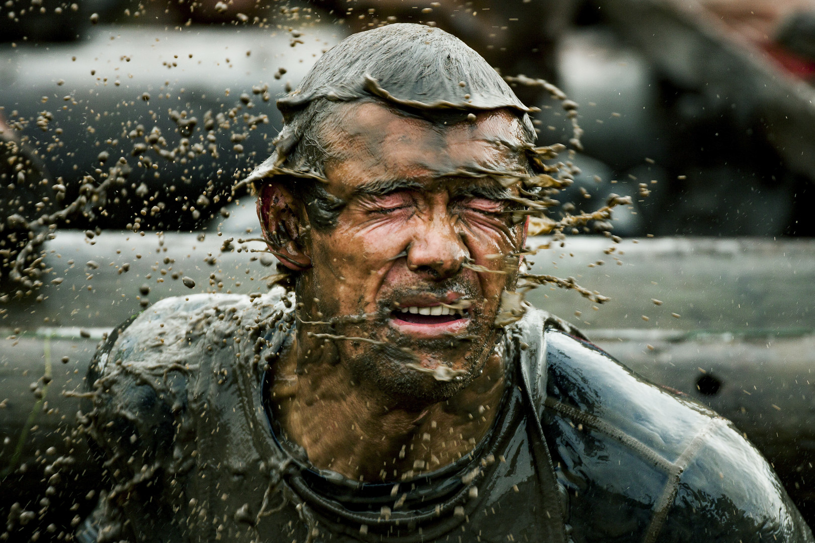 Man shaking off mud in a mud race.