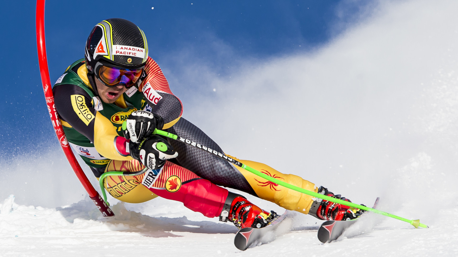 John Kucera racing past pole in alpine ski race.