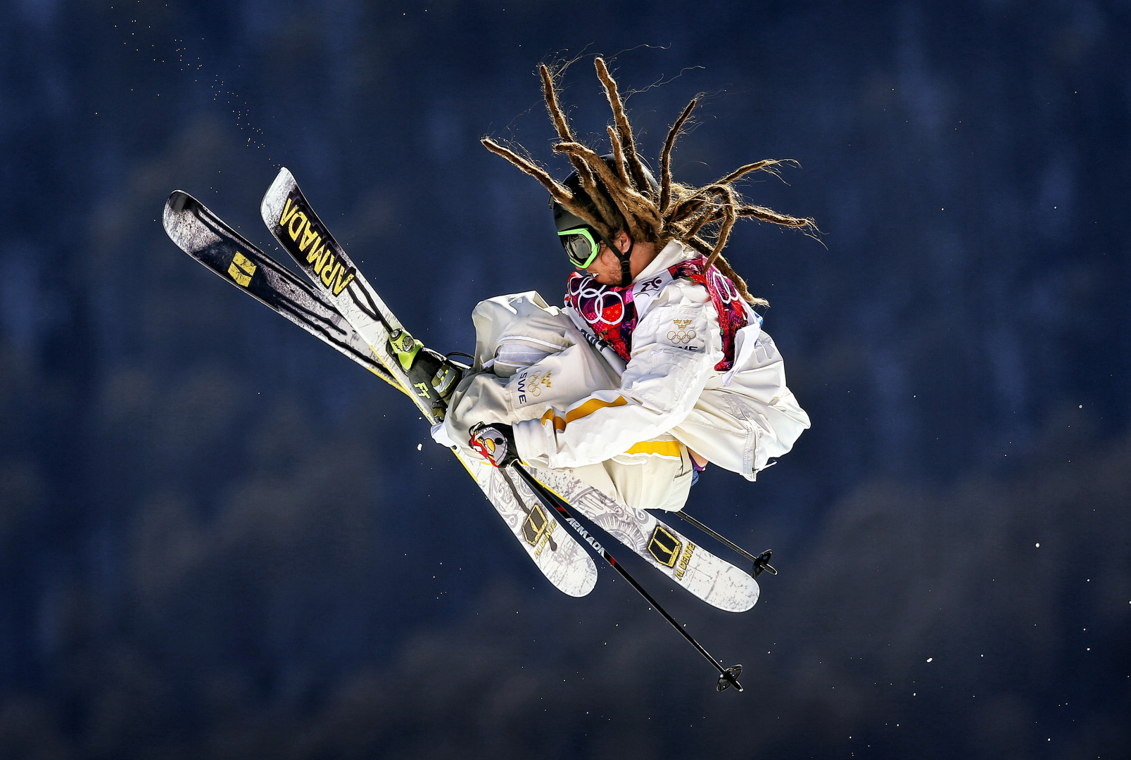 Henrik Harlaut performing jump mid air during ski race.