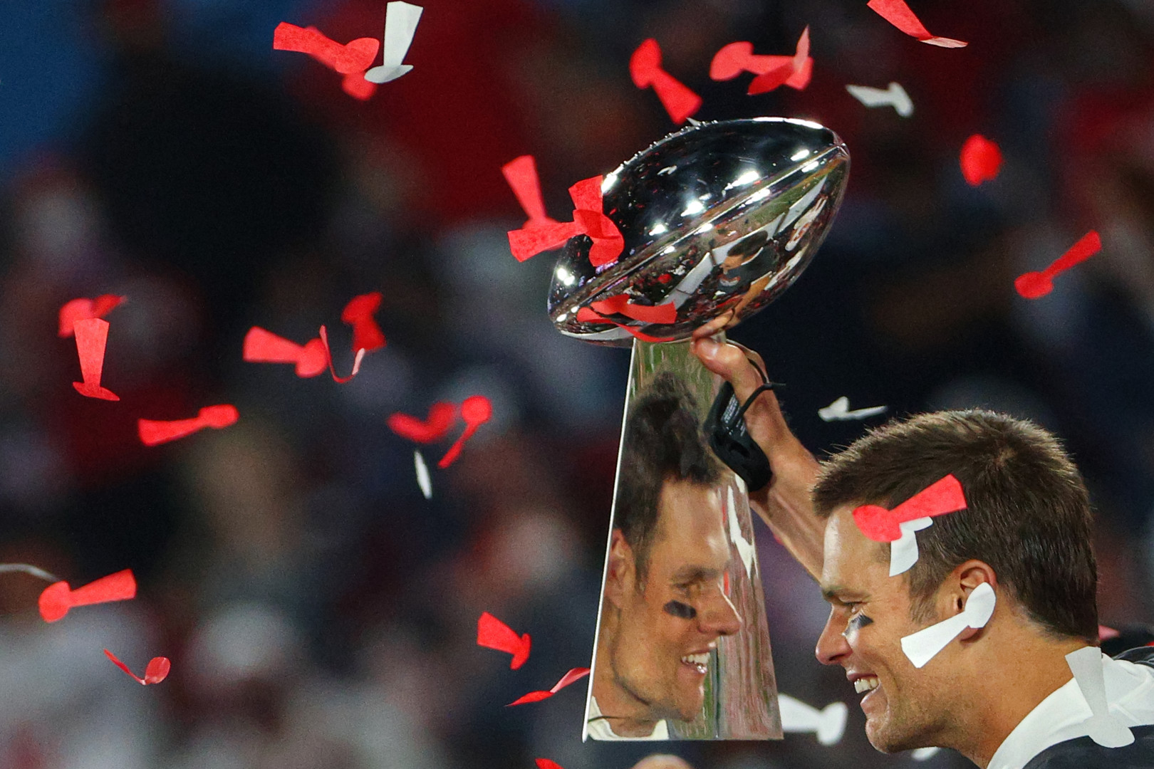 Close up image of American Football captain lifting the trophy.