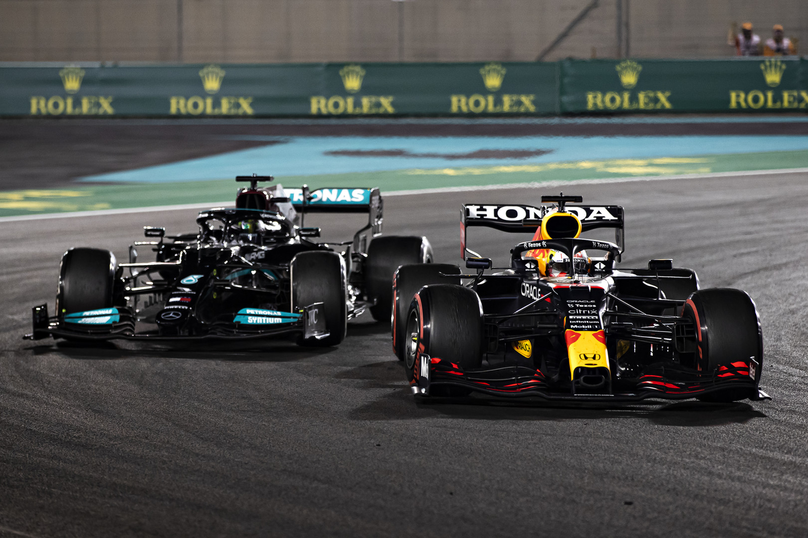 Max Verstappen passing Lewis Hamilton on the bend of the track during Championship race.