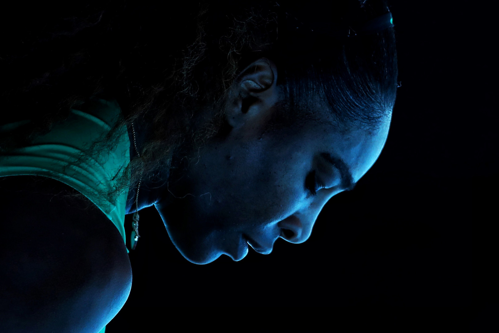 Blue highlight on Serena Williams as she composes herself to serve.