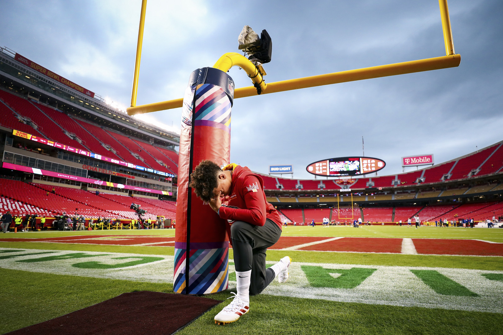 Kevin Sabitus knelt holding the field goal base with his head bowed.