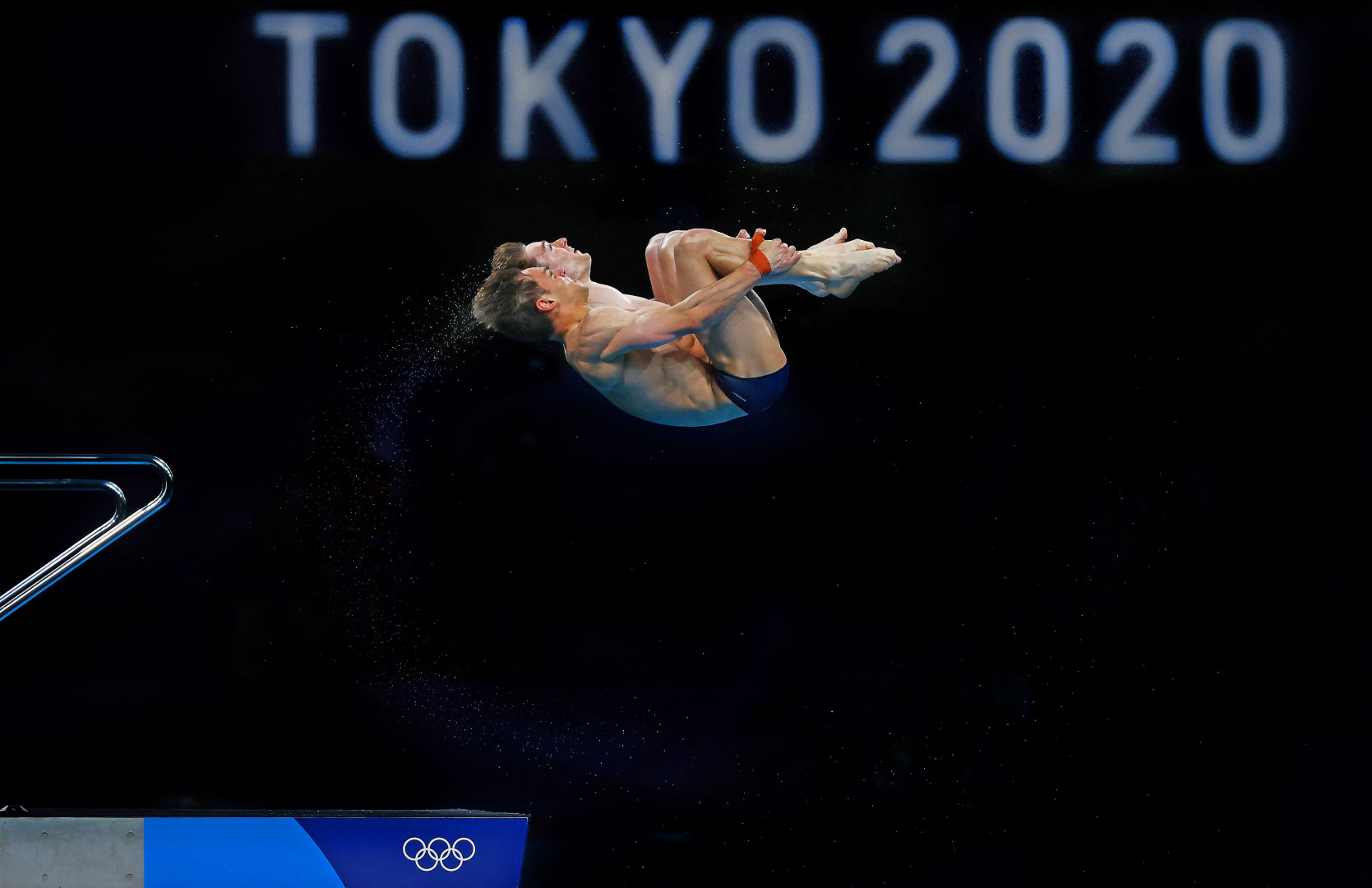 Two male synchronised divers moments after jumping off the diving board.