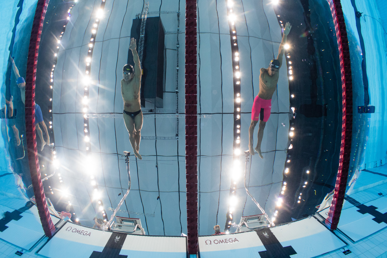 Underwater fisheye photograph of Paralympic swimmers during a length of front crawl.