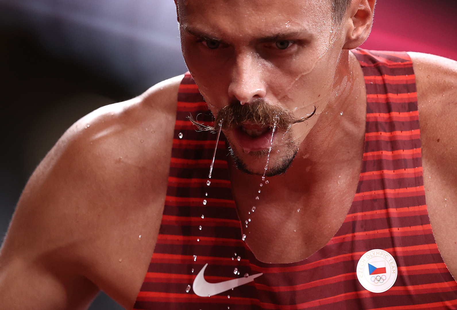 Close up of Czech Republic athlete dripping with water after being splashed by a bottle.