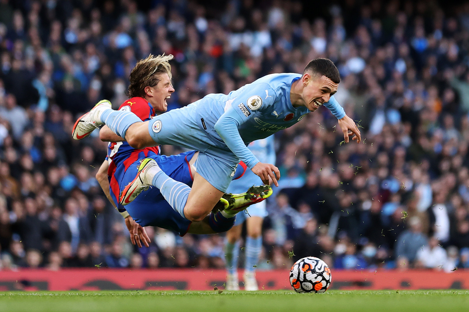 Crystal Palace player mid air taking out Phil Foden as he hurtles towards the floor.