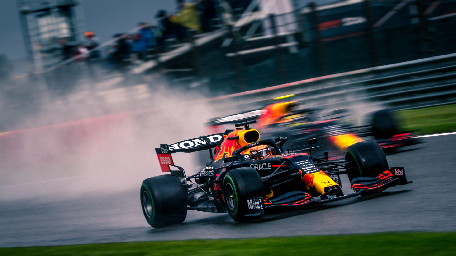 Red Bull team mates racing on the track in a blur of motion and movement.