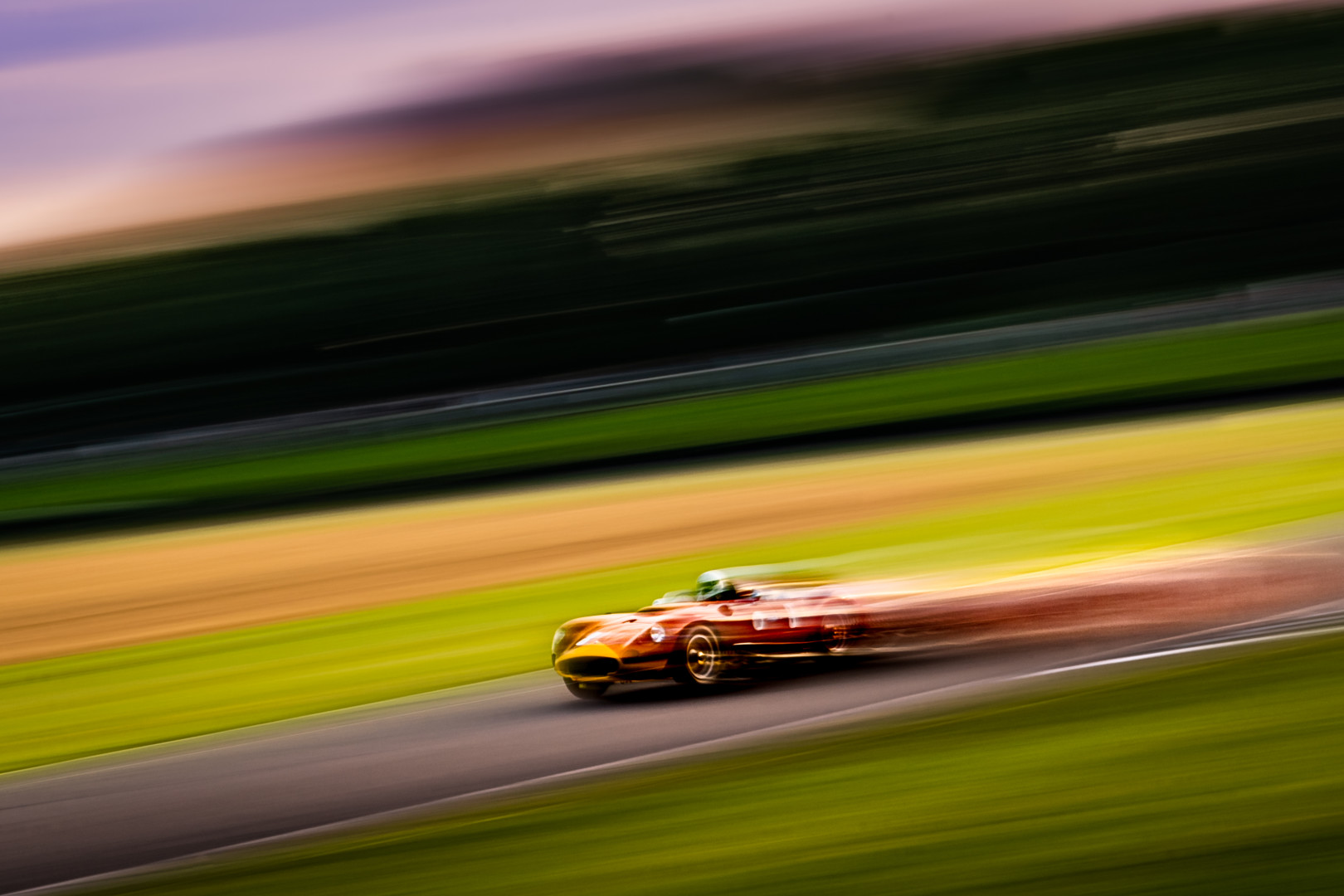 Old sports car racing in a blur of motion and colour at the Goodwood Revival festival.