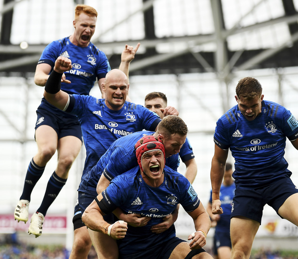 Leinster Rugby team mates celebrating a try.