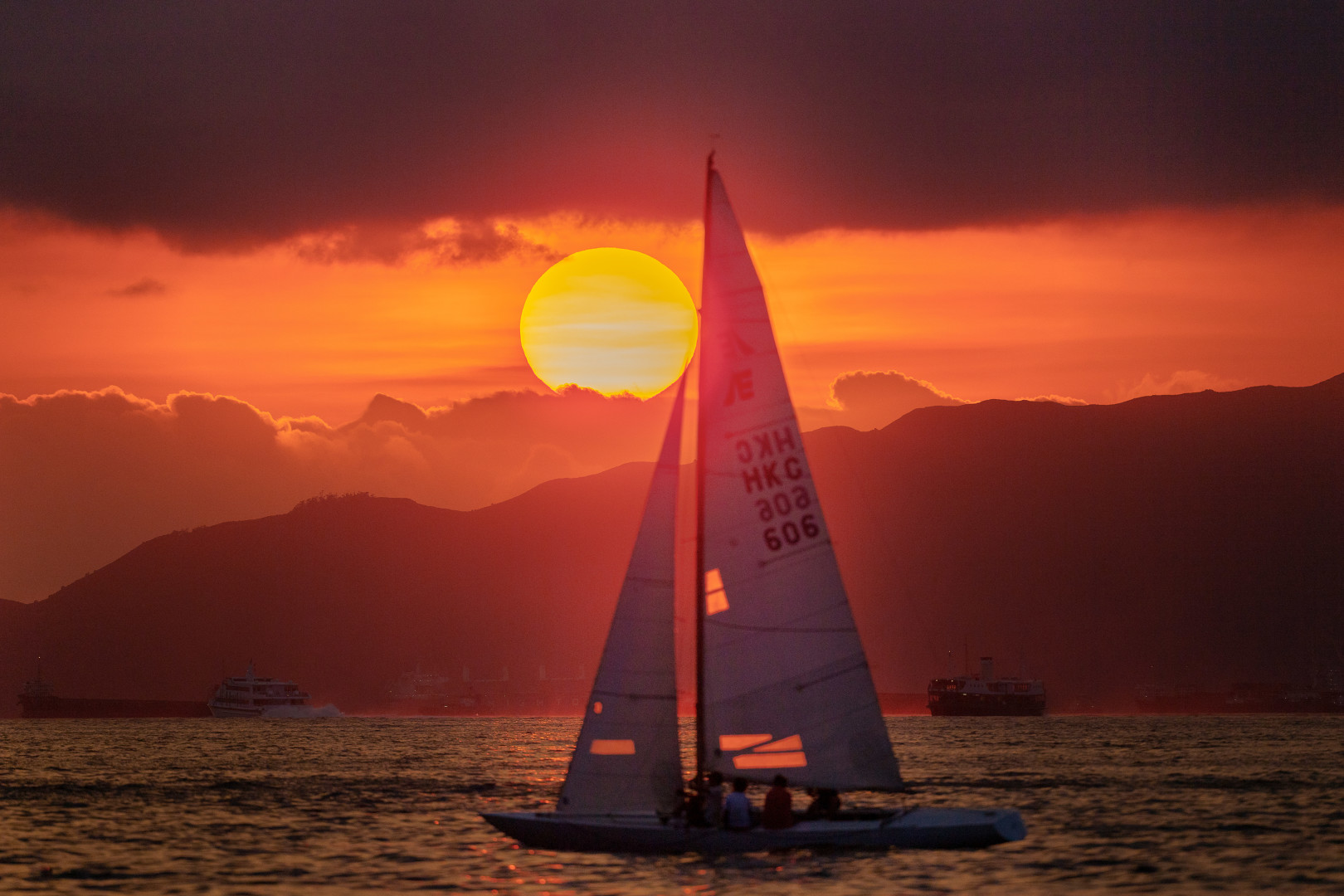 A yacht sailing at sunset.