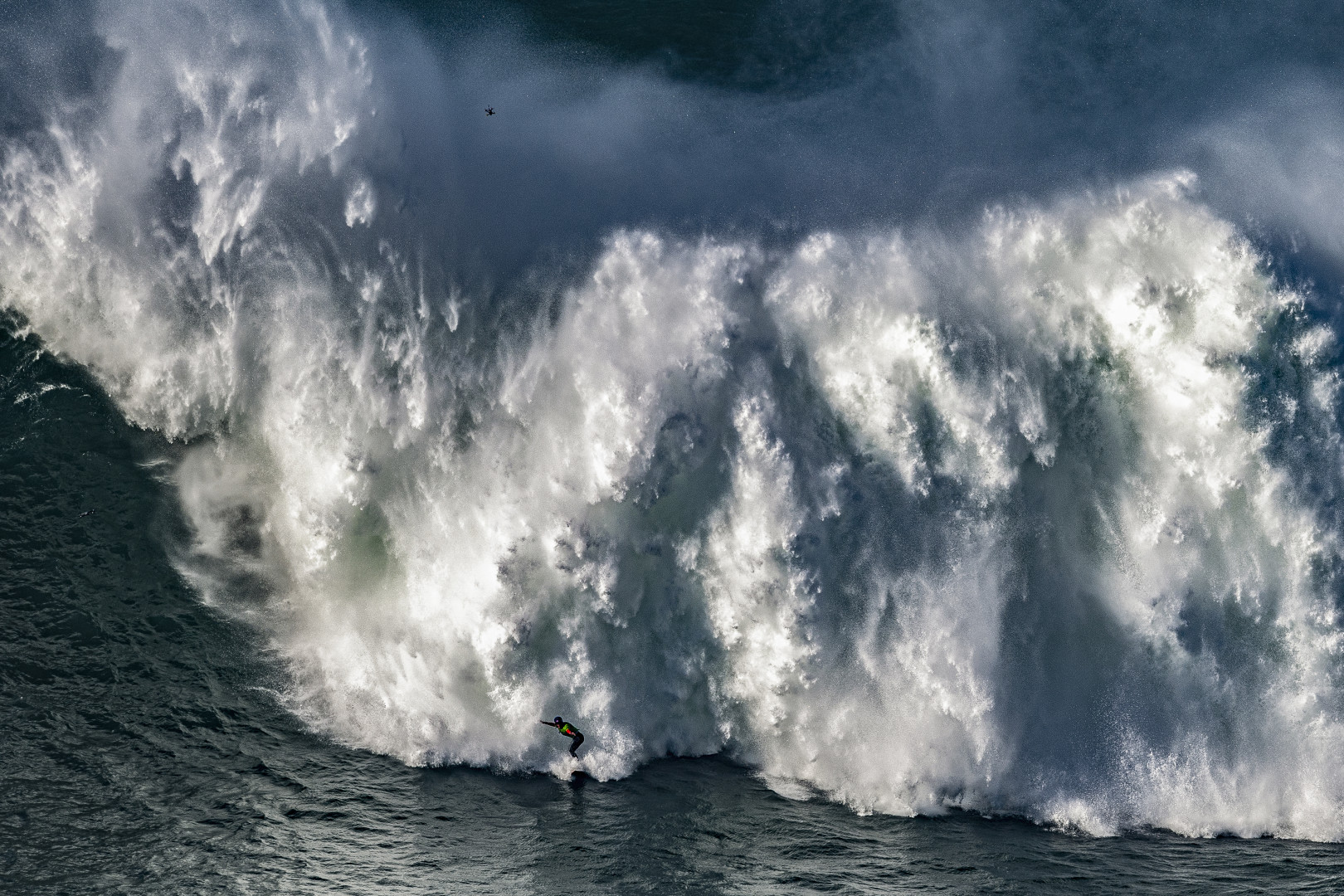 Surfer, Justine Dupont, being chased by a huge wave.